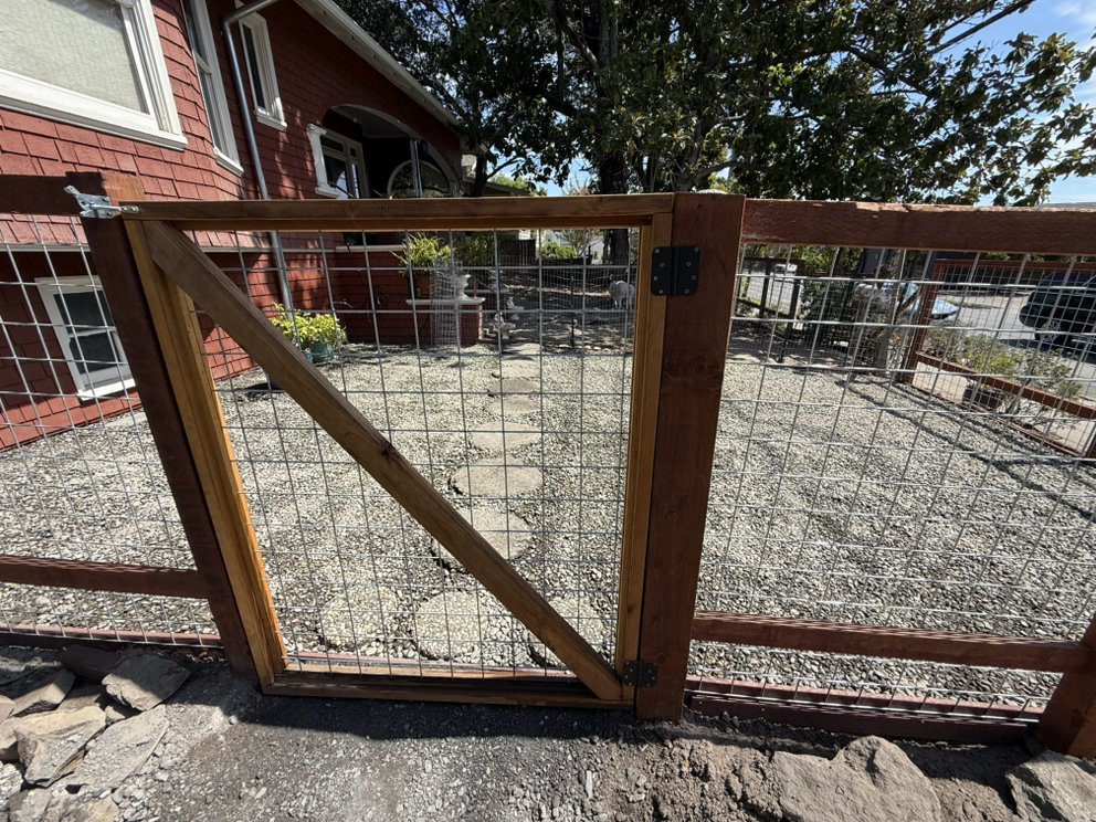 Cedar and wire mesh fence gate installed at a residential home